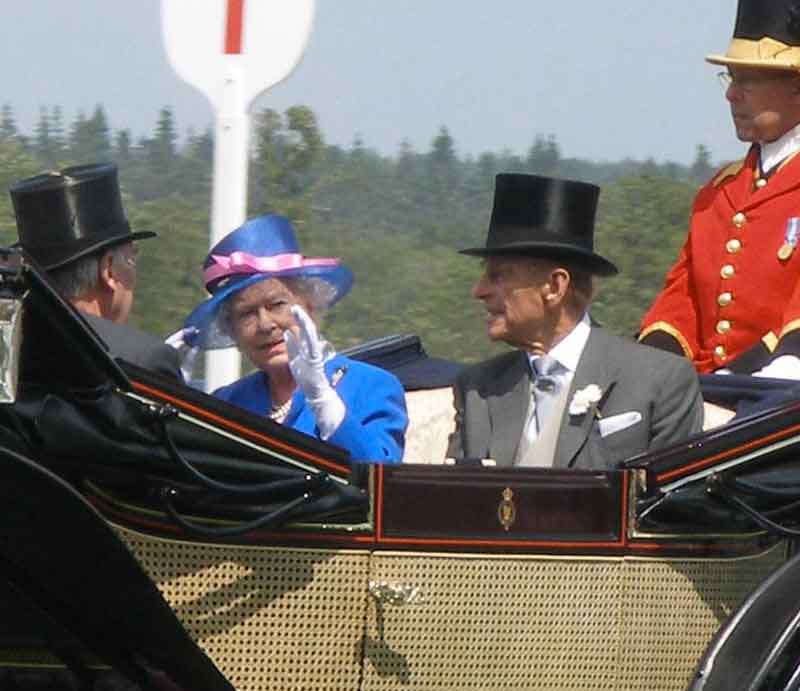 The Queen in a horse-drawn carriage.