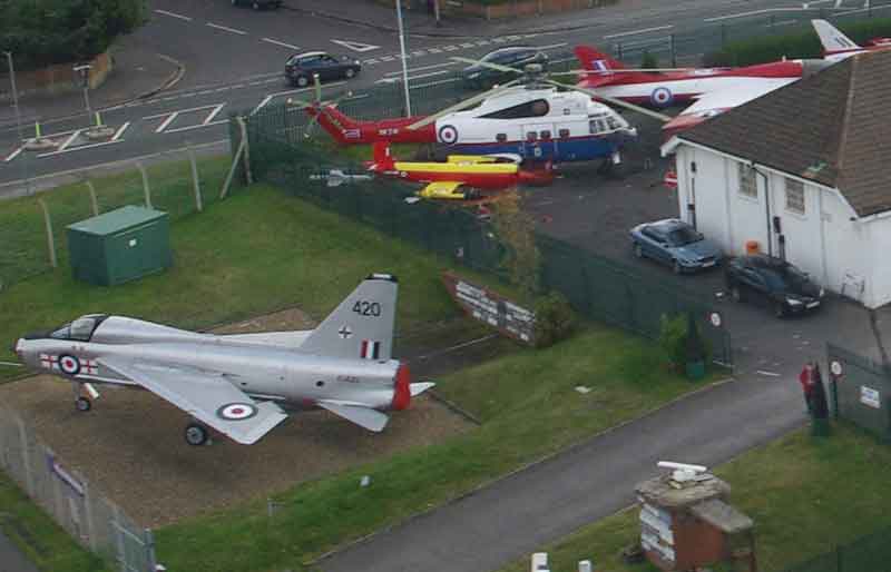 Aerial view of museum with jets and helicopter.