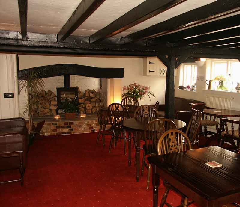 INterior with open fireplace and period ceiling beams.